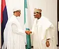President Muhammadu Buhari (left) wearing a babbar riga