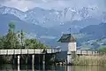 The wooden bridge, as seen from nearby Seedamm, Obersee and Wägital in the background