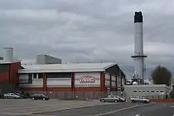 Image 36Heinz, although based in Hayes in Middlesex, has the largest food processing complex in Europe at a 55-acre (22 ha) site at Kitt Green in Wigan, which produces 1.4 billion cans of food each year; it is accessed to the east of the Orrell Interchange of the M6 (A577); the 38-acre Heinz NDC is next door (from North West England)