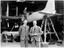 photograph of the aircraft along with its designer and test pilot