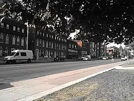 group of buildings alongside a large street with many cars