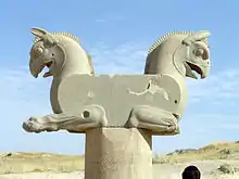Griffin capital at Persepolis. The roof timbers presumably filled the flat side surface
