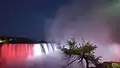 A view of Horseshoe Falls with the Canadian flag at night time.