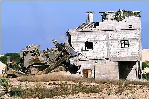 An IDF D9 demolishing a house in the Gaza Strip during the Second Intifada