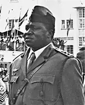 Idi Amin stands in military uniform