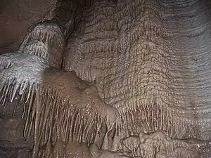 Image 53A flowstone formation inside Chimney Dome, part of Illinois Caverns in Monroe County. The cave is formed in limestone and dolomite by water dissolution and features stalactites, stalagmites, rimstone dams, flowstone, and soda straws.Photo credit: A. Frierdich (from Portal:Illinois/Selected picture)
