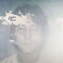 a hazy photo of John Lennon’s face with the title and artist name printed on a white cloudlike area near his forehead.
