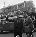 An officer of the Royal Netherlands Army asks directions from a Metropolitan Police Officer in London, 1942.