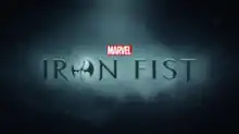 Iron Fist written in black writing, the letter O written in the form of a stylized dragon.