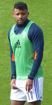man in football training kit on a grass pitch