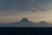Isanotski (8104ft, 2470m) and Roundtop (6128ft, 1871m) volcanoes as seen from the Unimak Pass in the morning light.