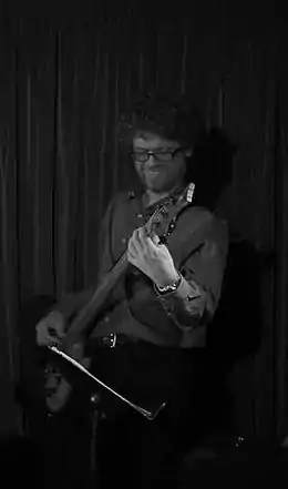 Man playing a bass guitar.