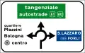 Directions at a roundabout in urban areas. The green panel indicates a motorway