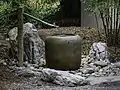 Stone water fountain and cistern at the Japanese Garden at Norfolk Botanical Garden, Norfolk, Virginia.