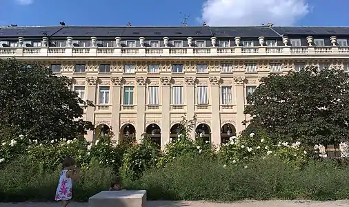 Unified facade of town houses overlooking garden