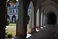 The statue of Jesus in the cloister garden viewed from the walkway near the Church