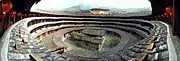 A tulou outer building encloses a smaller circular building, which encloses an ancestral hall and courtyard in the center.