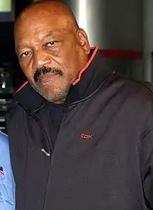 Jim Brown, wearing a jacket, poses for a picture.