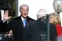 Photo of Biden raising his right hand, reciting the Oath