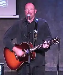 Cash sings and plays guitar