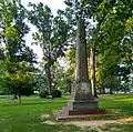 Monument to Joseph Caldwell on UNC campus, with Davie Poplar in the background