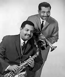 Cannonball (left; holding a King Super 20 "Silversonic" alto saxophone) with brother Nat Adderley in 1966