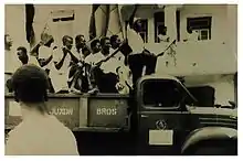 Blyden and supporters riding on the back of an open truck in 1957 election