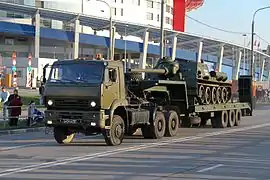A Russian KamAZ military tank transporter carrying an SU-85M