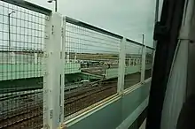 View from a bus on the Kansai International Airport Access Bridge, showing that a section of the bridge has broken in two.