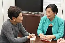 Photo of a conversation between Kathy Matayoshi and Mazie Hirono