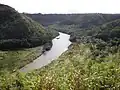 Poliʻahu Heiau view of Wailua River, Kamokila Hawaiian Village (at right), and Fern Grotto tour boat
