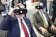 Two men using VR headsets in 2018. The same year Steven Spielberg's Ready Player One released, which featured Vive Virtual Reality headsets and helped advance motion capture.
