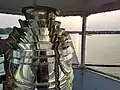 The 5th order Fresnel Lens in Kewaunee's Pierhead lighthouse sees one of its last sunsets before being removed