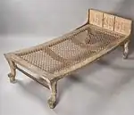 Wooden bed with strung mattress and leonine legs