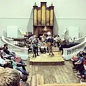 A youthful band playing in the Room