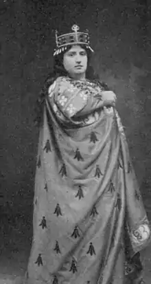 White woman in stage costume of medieval robes and a coronet