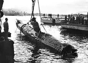A Japanese Kō-hyōteki class midget submarine M-21 being raised from Taylor's Bay on 1 June 1942