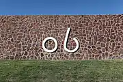 The Kokernot Ranch "06" brand on a rock wall at Kokernot Field.