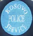 Former cap badge of the Kosovo Police Service