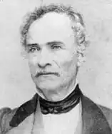 Black-and-white photograph of a middle-aged man, facing the camera.