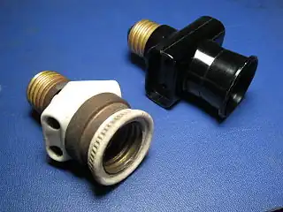 Italian bypass lampholder plugs with Edison screw mount. Left: early type (porcelain and brass, c. 1930); right: late type (black plastic, c. 1970)