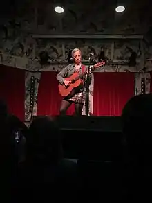 Veirs onstage playing guitar