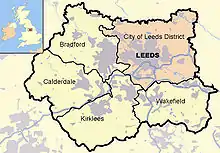 Leeds district (pink),other four metropolitan boroughs of West Yorkshire (clockwise from Leeds: Wakefield, Kirklees, Calderdale and Bradford). County and borough boundaries are black, urban areas grey, motorways blue with white stripe, rivers and bodies of water light blue. A Great Britain inset map shows  West Yorkshire highlighted.