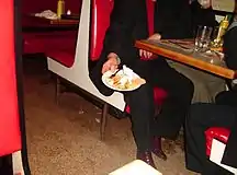 Restaurant patron showing his leftovers to be put in a "doggy bag"
