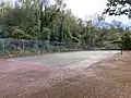 One of the tennis courts within the playing fields