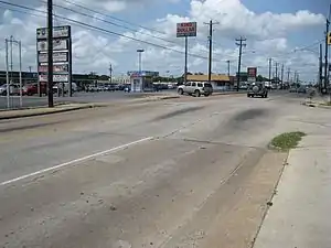 View is SW at Long Point Road and Lynnview. Upthrown side of the Long Point Fault is to the right. Fault passes to the left of the kiosk.