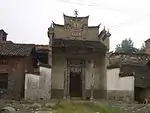This shrine to a Master Yong in a Yangxin County village, Hubei features a tablet, high in the facade, saying "The Three Stars are Present". The symbol at the top of the facade is a stylised derivation of the character shou , "longevity"