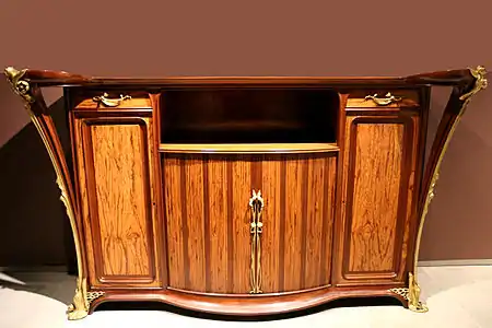 Exotic materials and decoration.  Mahogany and amourette wood cabinet with water lily decoration of gilded bronze by Louis Majorelle (1905–1908)