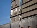 some lower west wall faces of caseros prison with Huracan bandera. July, 2006.