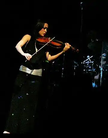 Micarelli playing the violin during Josh Groban's 2007 concert in the Palais des Congrès, in Paris.